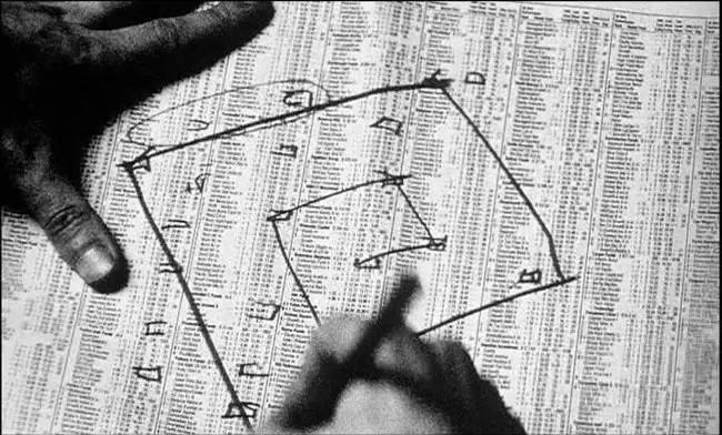 A hand drawing the golden ratio over a newspaper in Pi